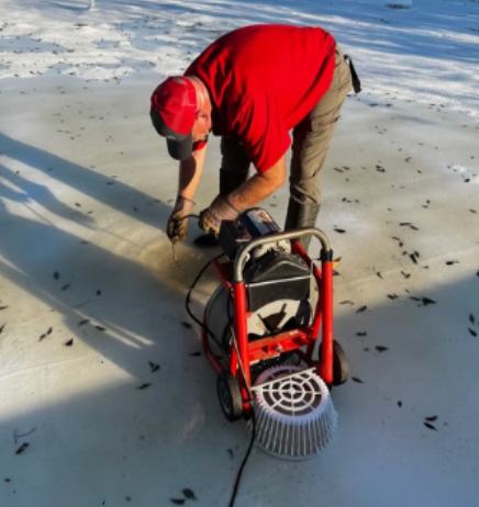 Direct Services technician operating a drain machine