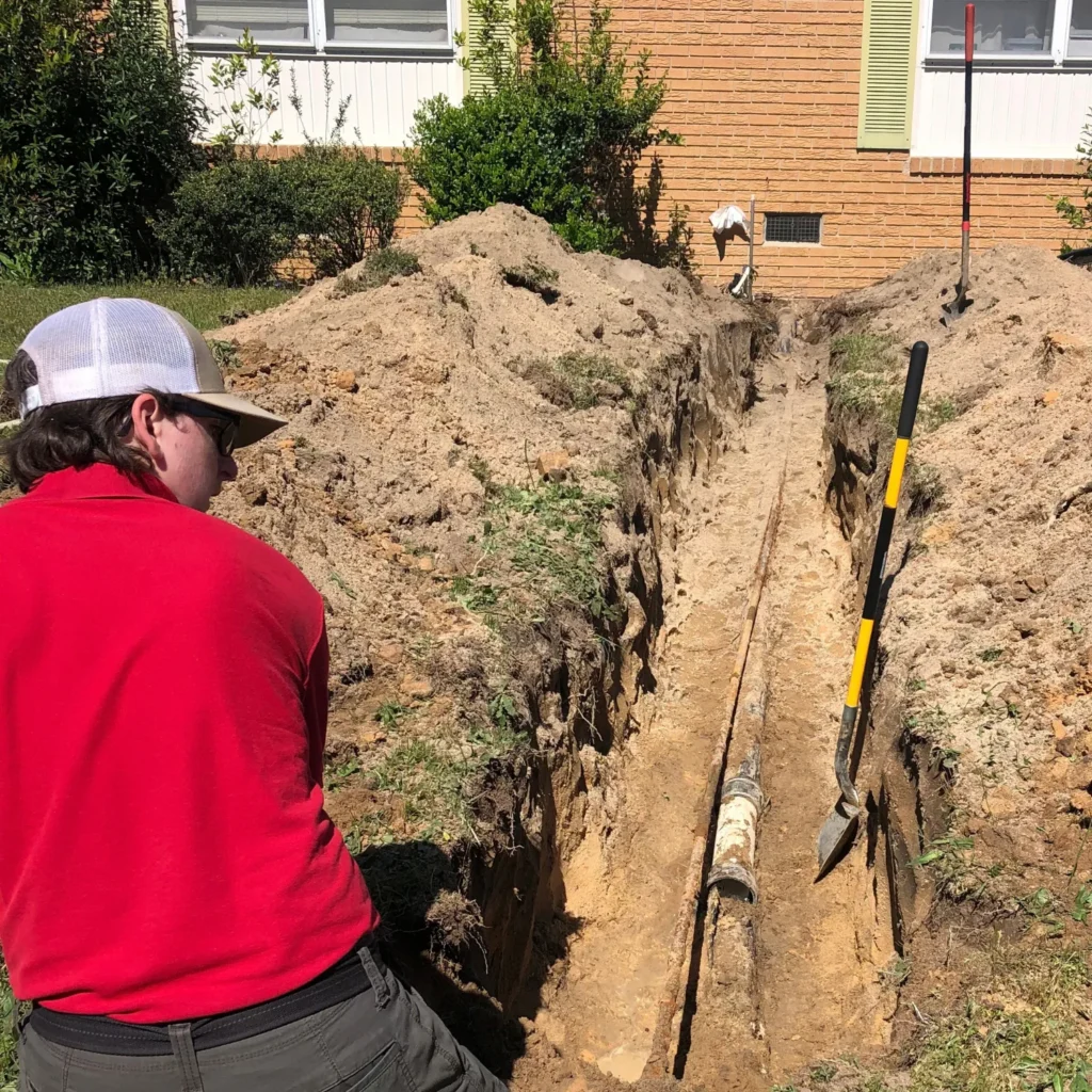Plumber working on a drain line at a customer's home.
