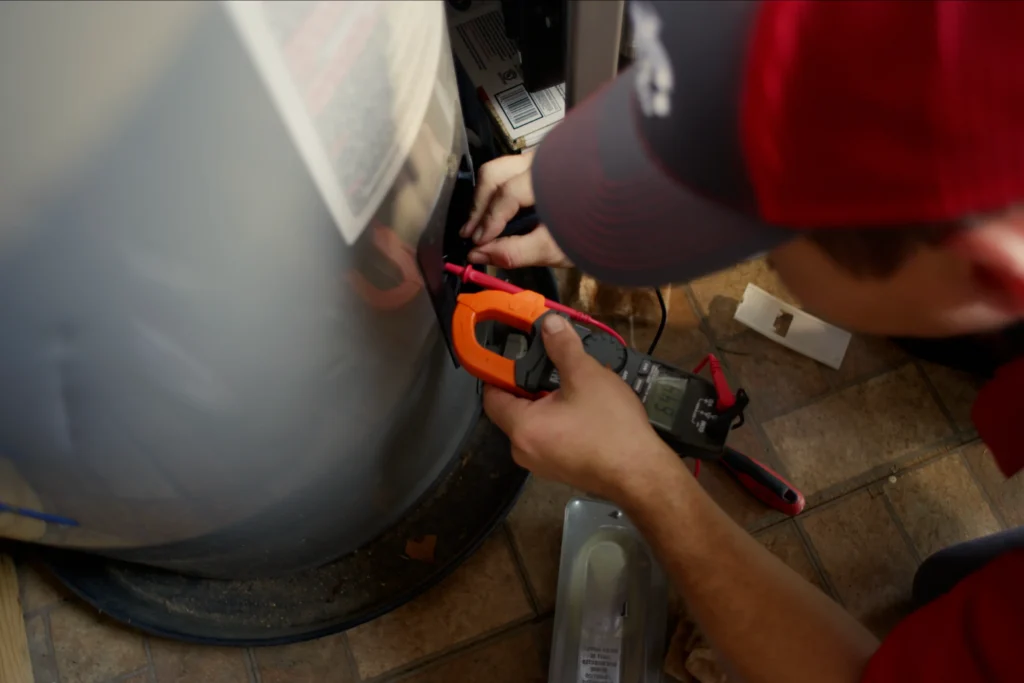 Plumber performing water heater repair service